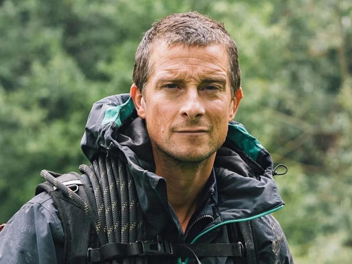 A wet-looking Bear Grylls looks at the camera.