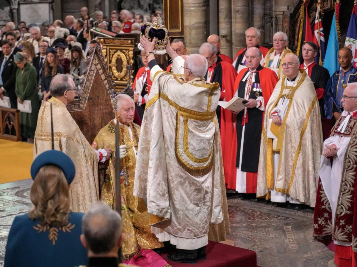 An archbishop crowns the king. 