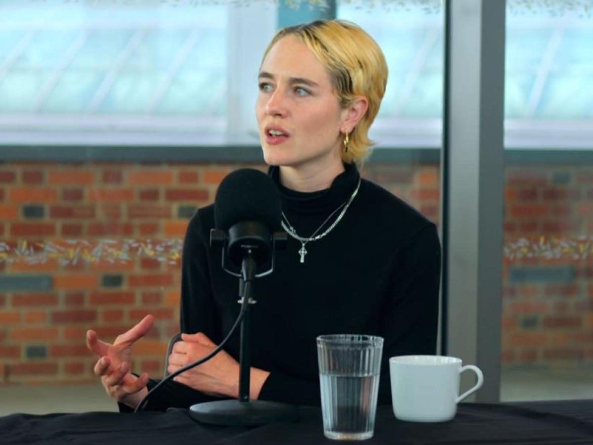 A podcast guest gestures with her hand while talking
