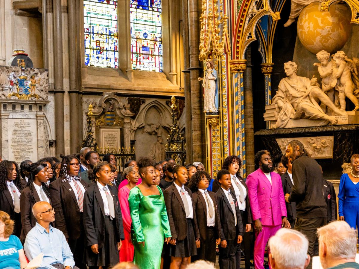 A school choir sings in an ornate abbey setting