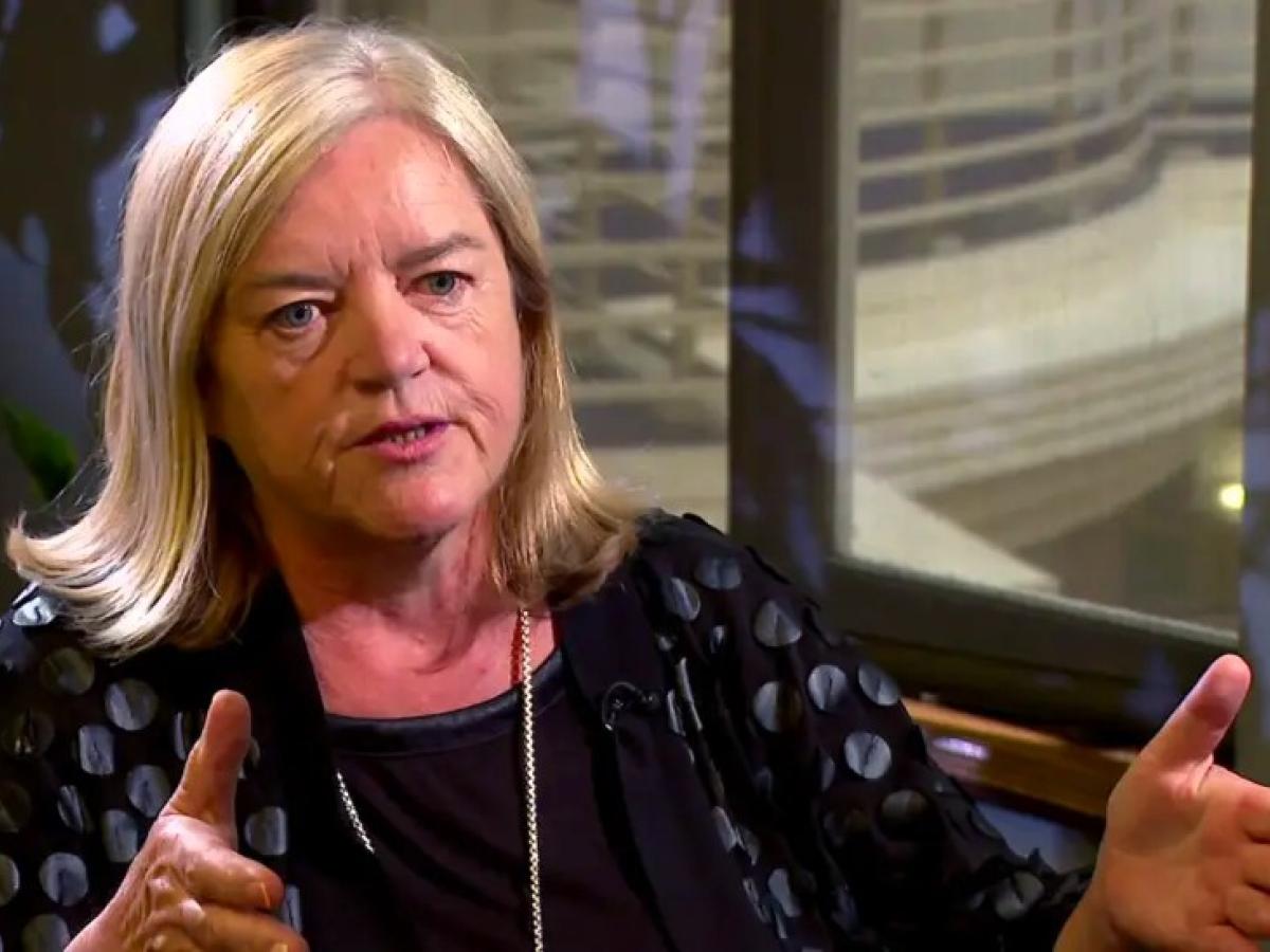 A woman talks in an interivew.