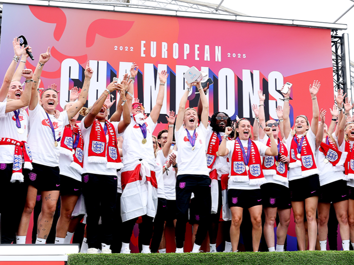A victorious women's football team celeberate.