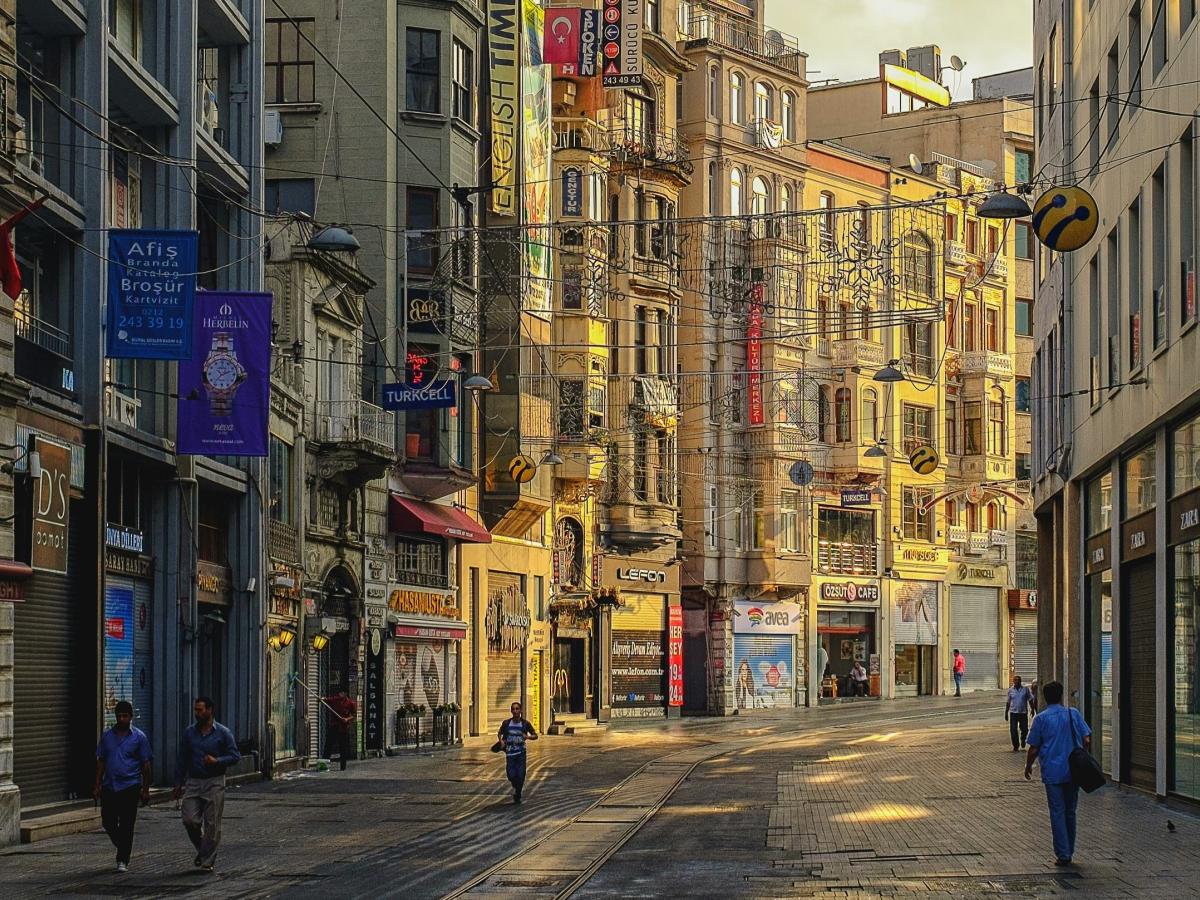 An Istanbul street curves and the sun illuminates one side
