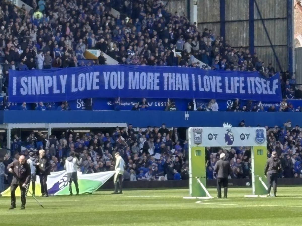 A football stand displays a long banner with text on it.