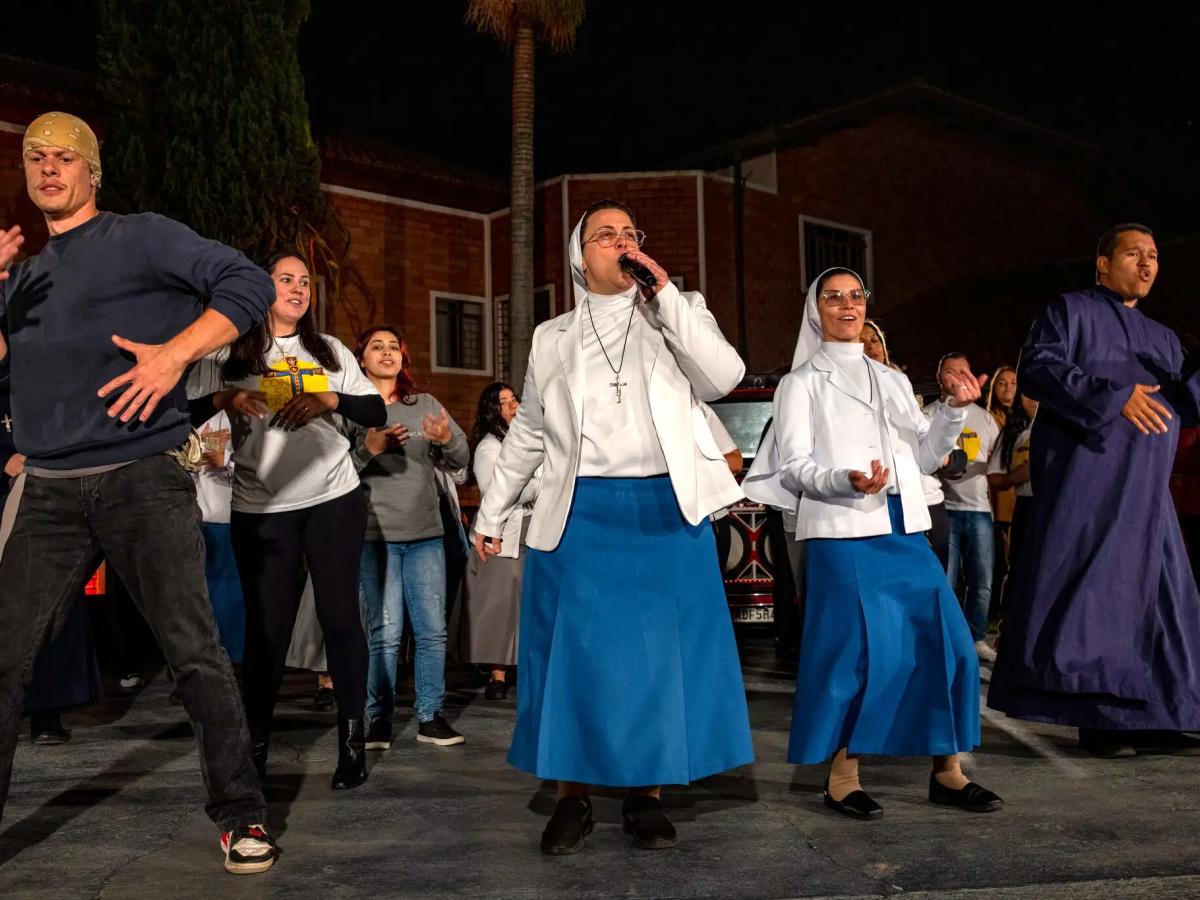 Two nuns with a band rap on stage