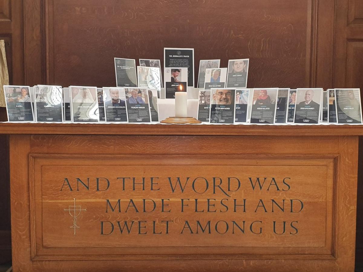 A church altar holds commemorative frames of killed journalists