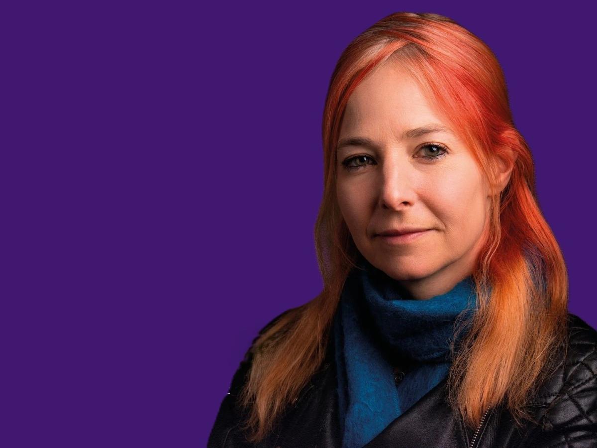 A head and shoulder image of Alice Roberts against a purple background