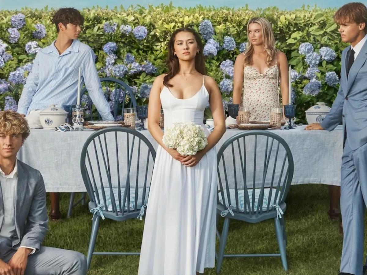 The cast of The Summer I Turned Pretty pose on a wedding set.