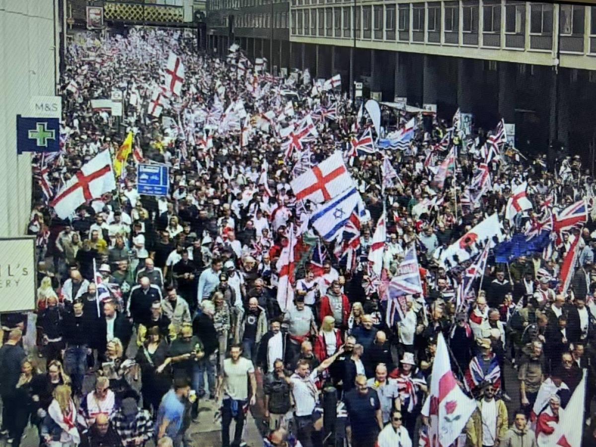 Marchers carry British, English and Israeli flags