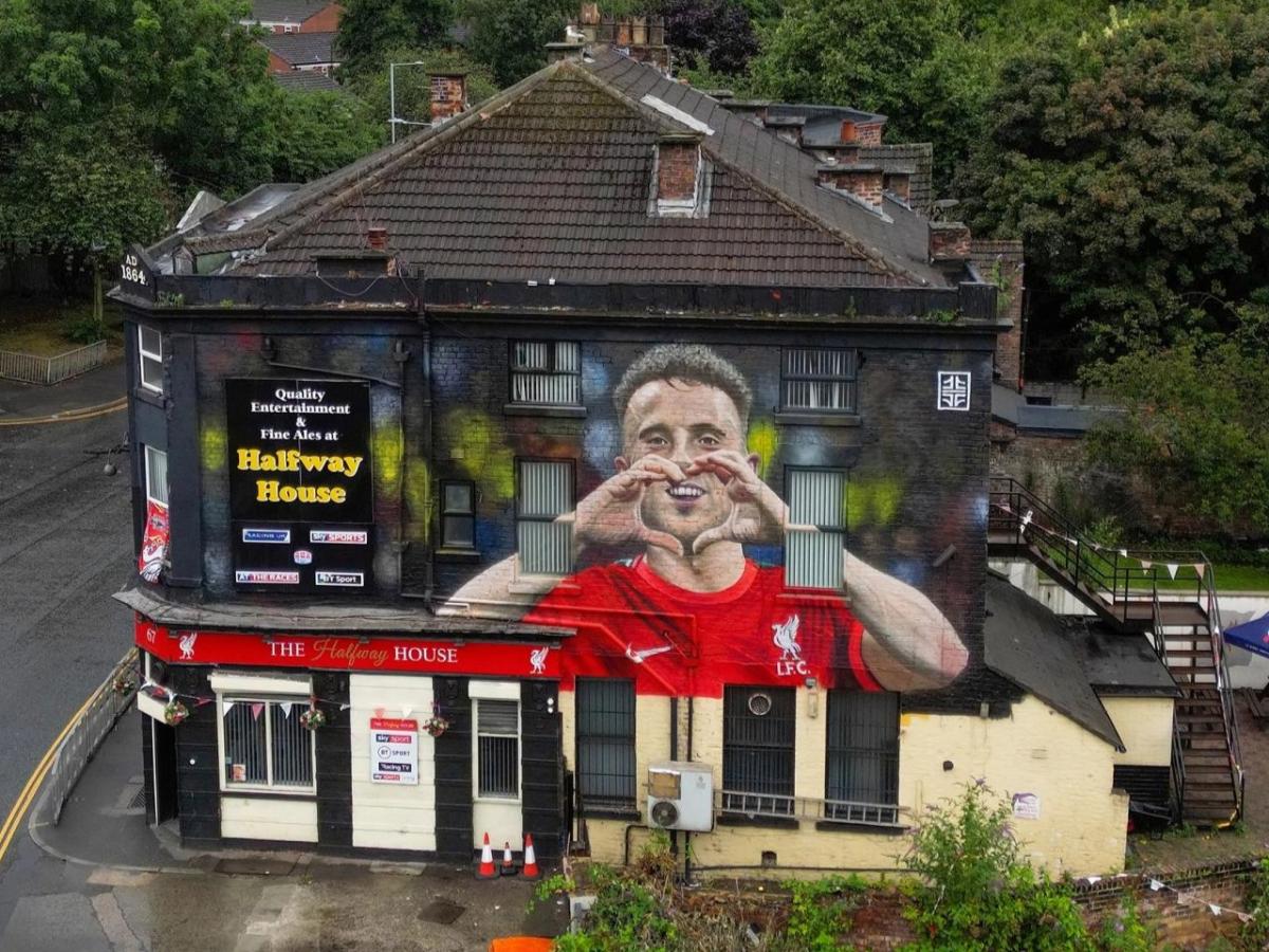 An aerial view of a pub with a large mural of a footballer on it
