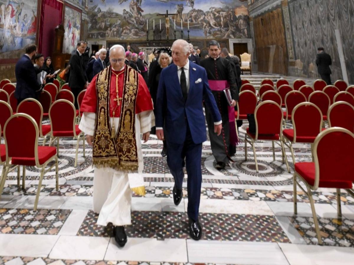 The Pope and King Charles walk together from the Sistine Chapel