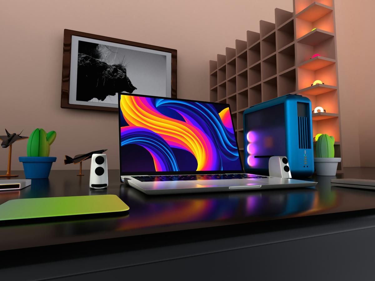 A flat screen on a desk displays a colourful pattern.