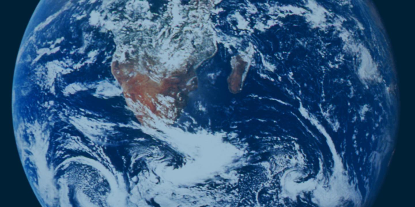 Planet Earth viewed in totality from space. Africa and Arabia are visible under some cloud in the south.