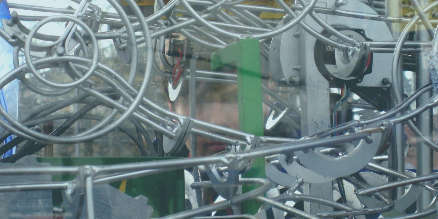 A complex of linear and metal parts in a machine-like sculpture.