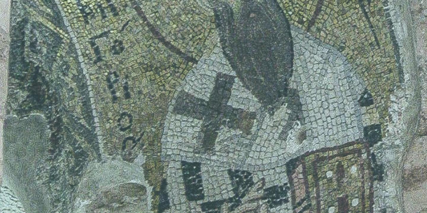 A mosaic shows a saint with a beard holding a bible and his hand held up in a blessing.