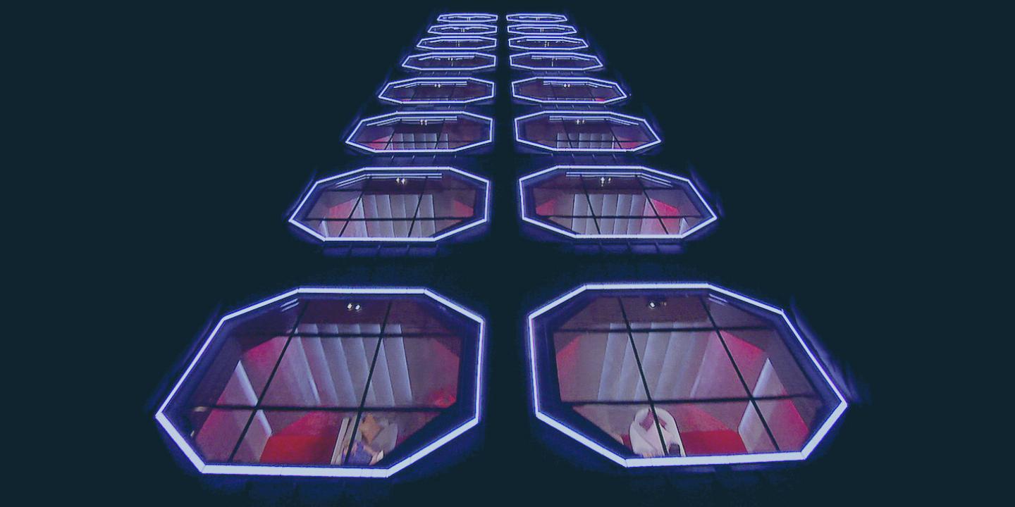 Looking down onto two rows of octagonal illuminated skylights over pods.