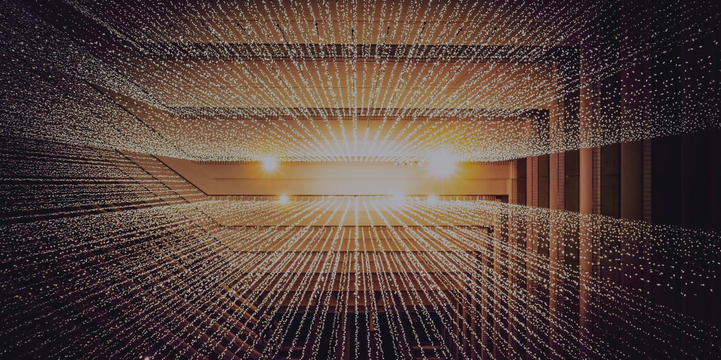 A CGI render of a grid of golden lines receding into the perspective