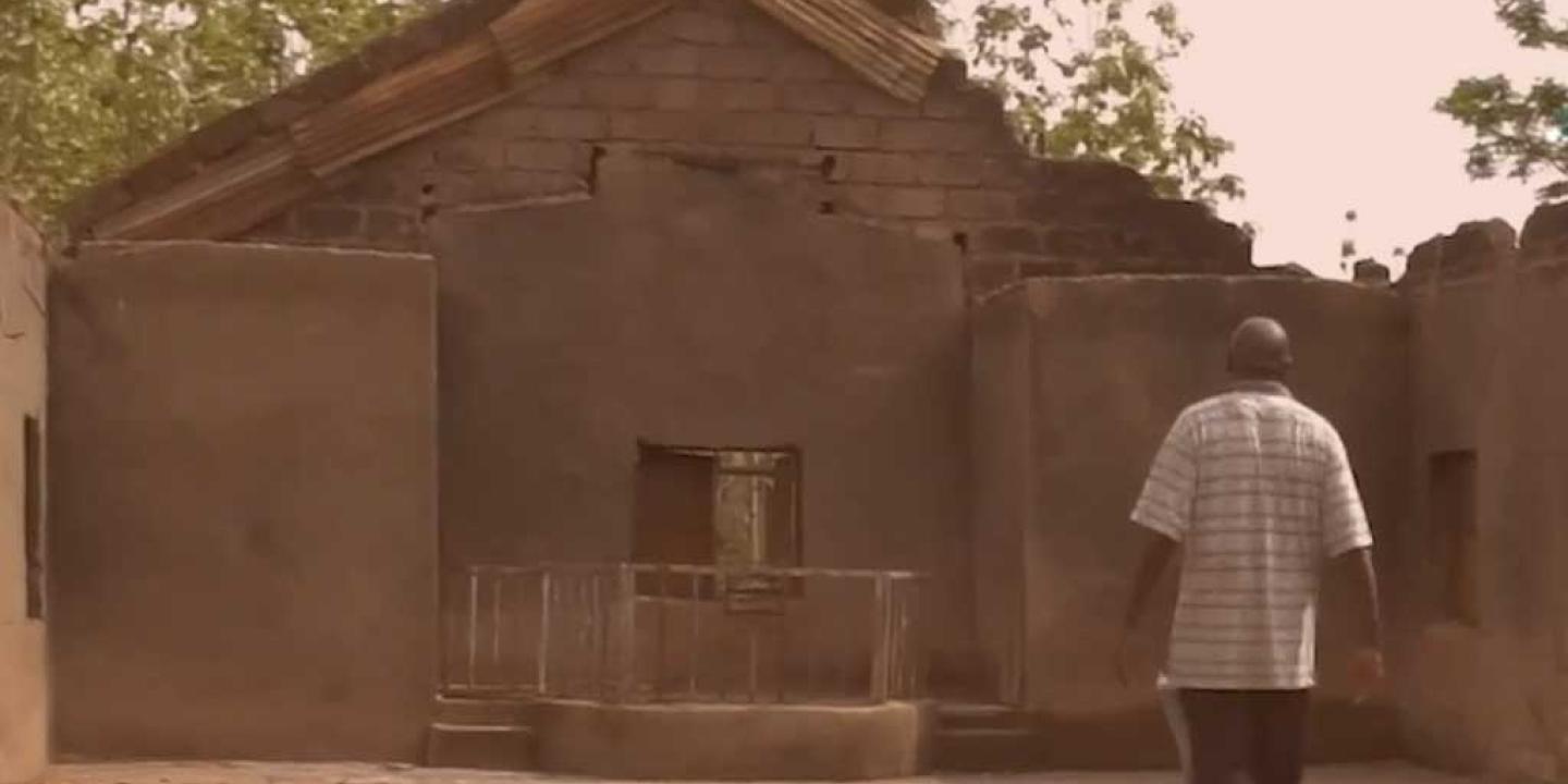A person stands in the burn out shell of a church in Nigeria.