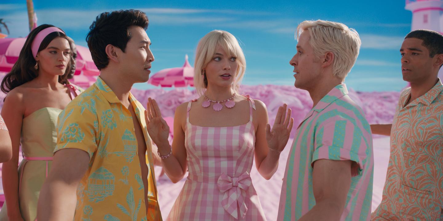 Barbie stands between Ken and a rival with her hands raised.