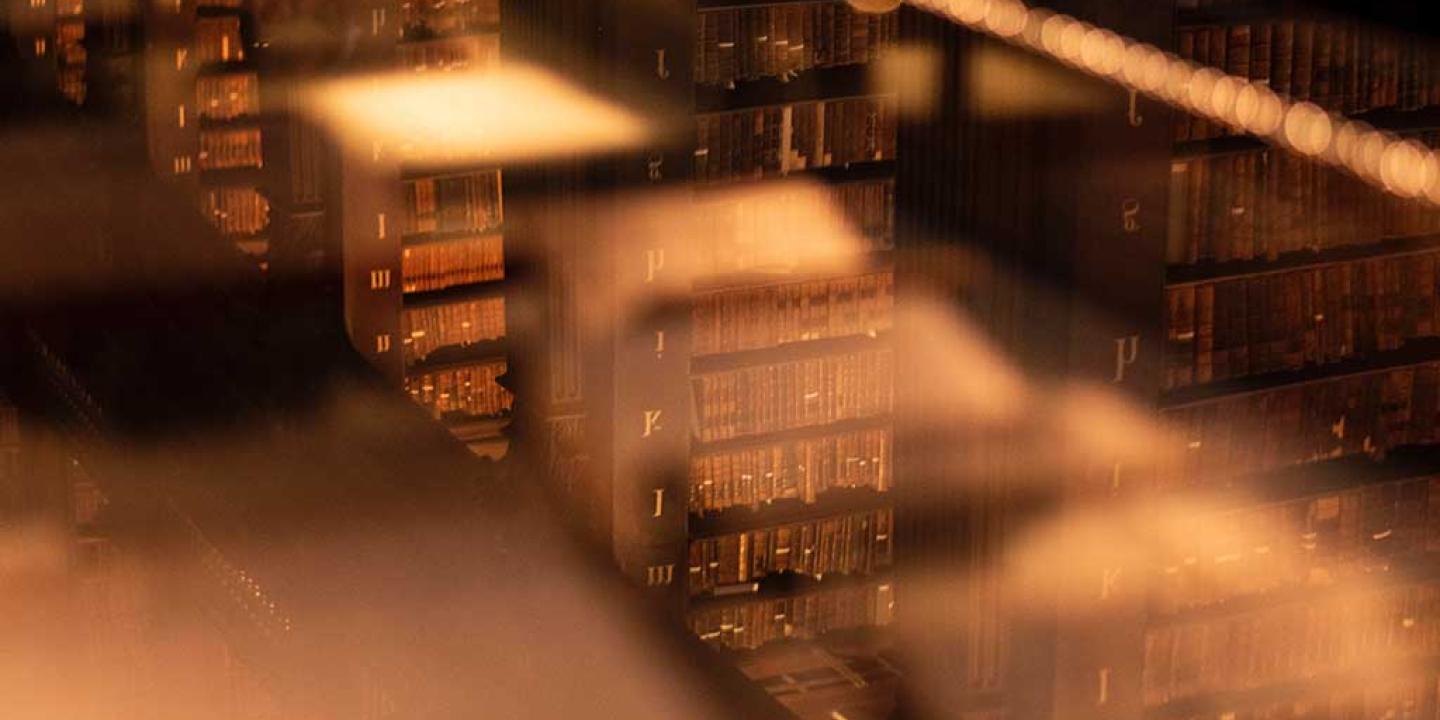 An unfocused views down on to stacks of books in an old library.