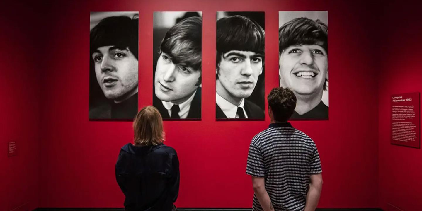 Two gallery vistor stair at four photo portraits of The Beatles.