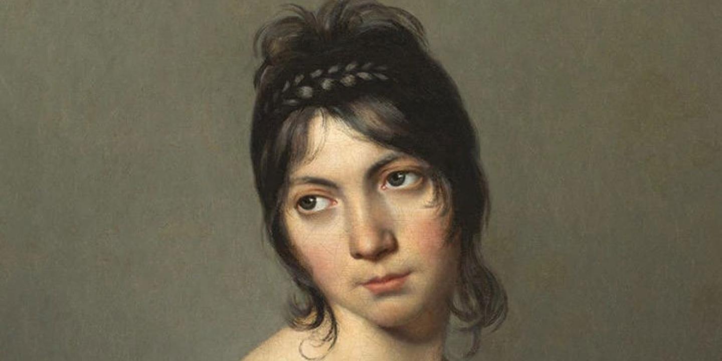 A head and shoulders portrait of a young woman inclining her gaze to one side.