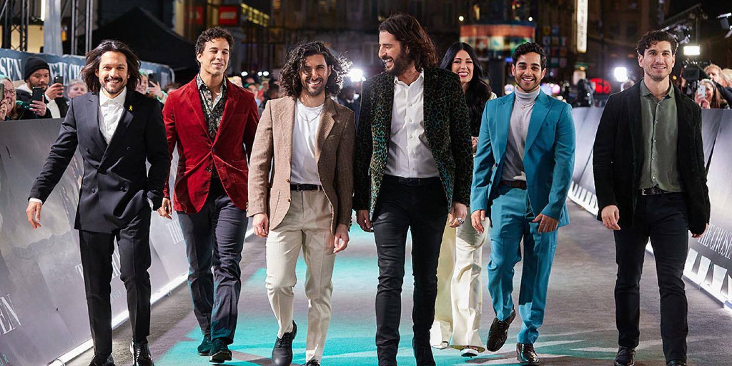 A group of actors walk together at a film premiere