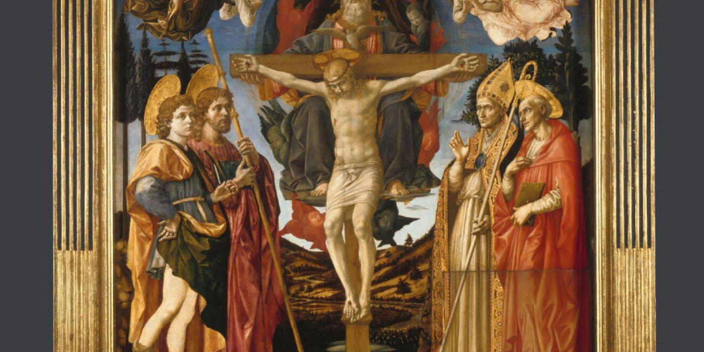 A painted altarpiece depicts a crucified Christ surrounded by followes, angels and soldiers.
