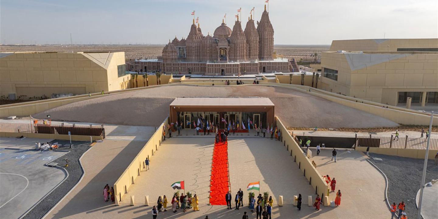 A red carpet lies on a grand entrance to a newly constructed Hindu temple.