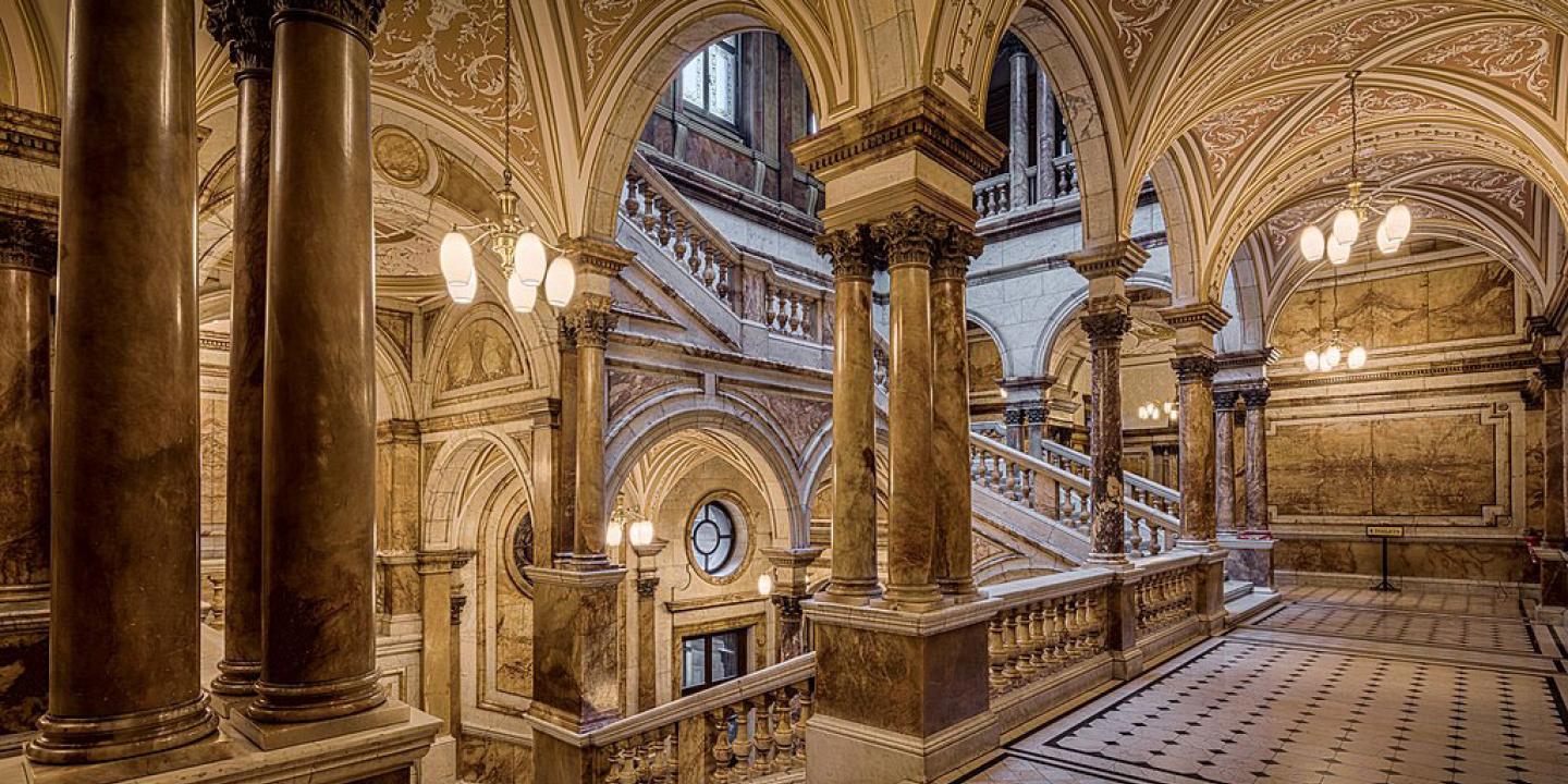 A marbles staircase rises on four sides of a chamber.