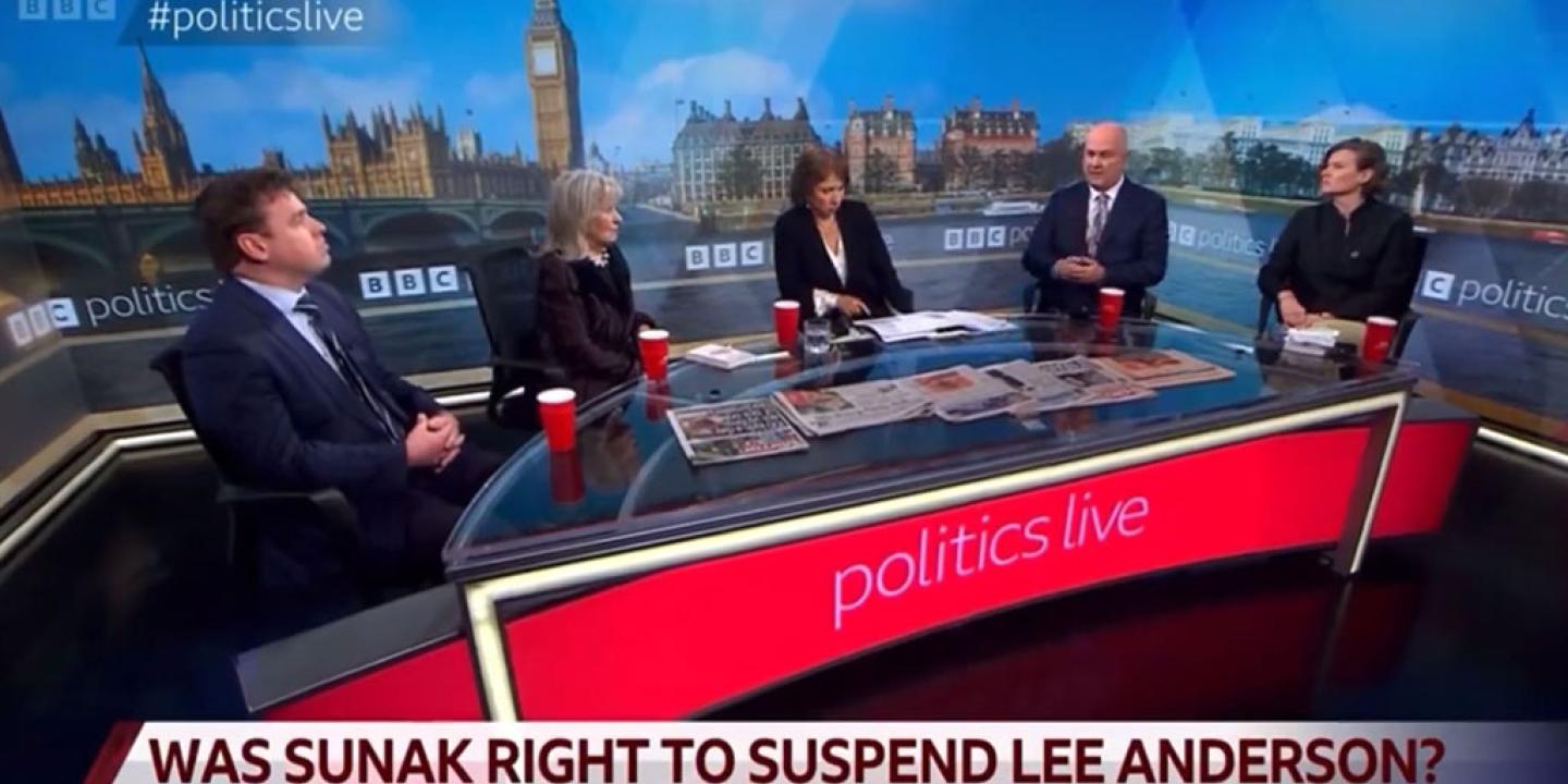 A TV roundtable discussion with five people against a backdrop of Parliament.