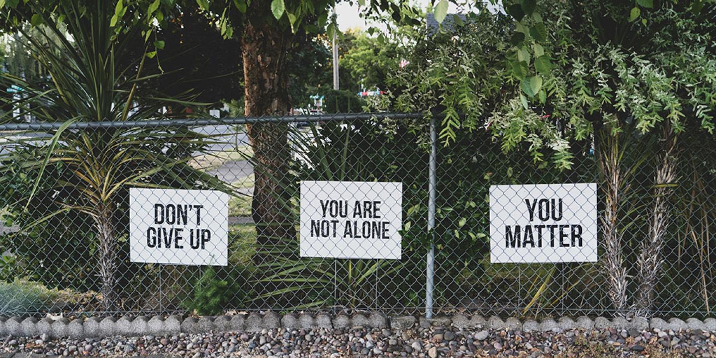 yard signs read: Don't give up. You are not alone. You matter.