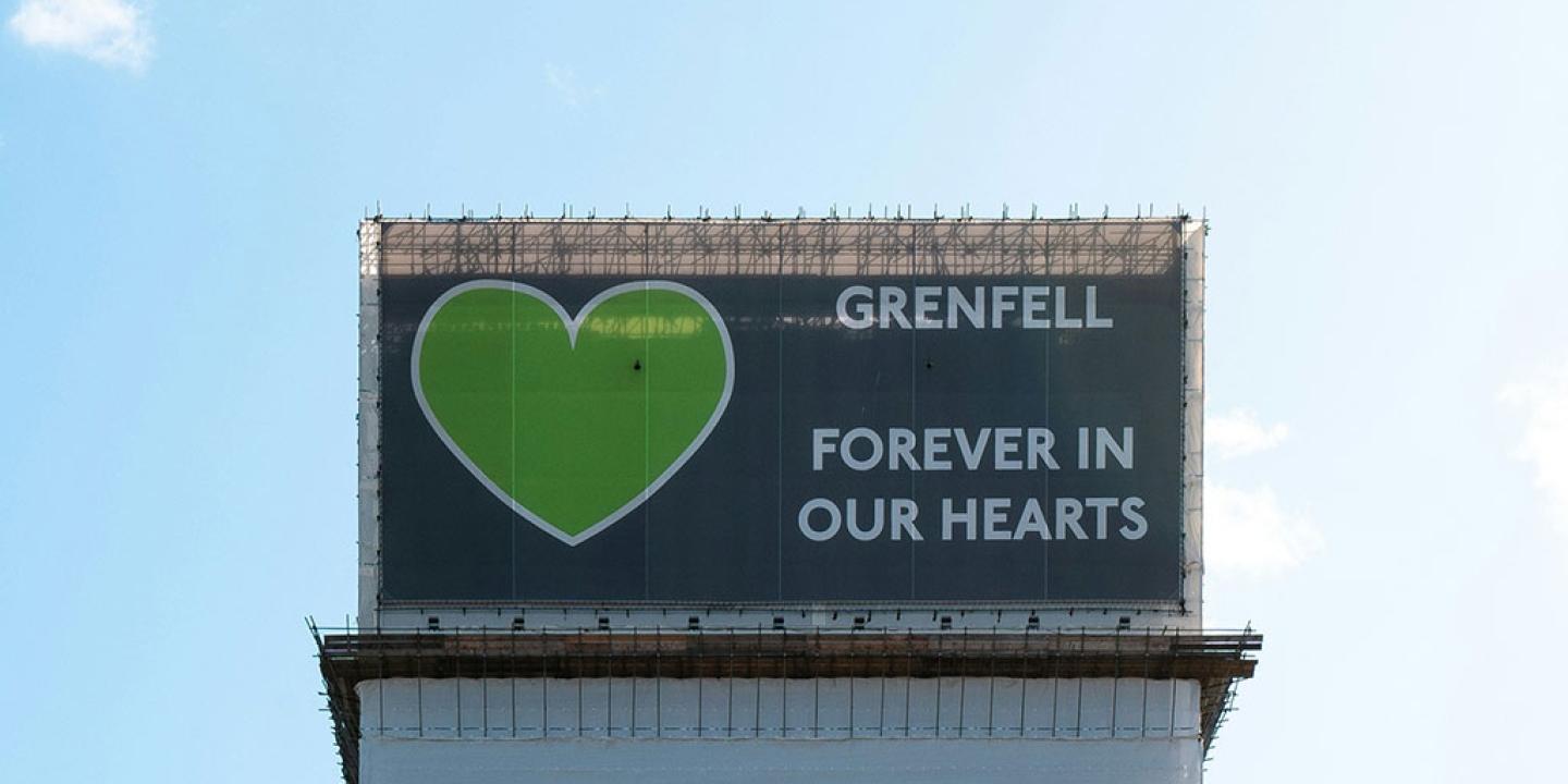 A wrapping around the Grenfell Tower bears a giant green heart.