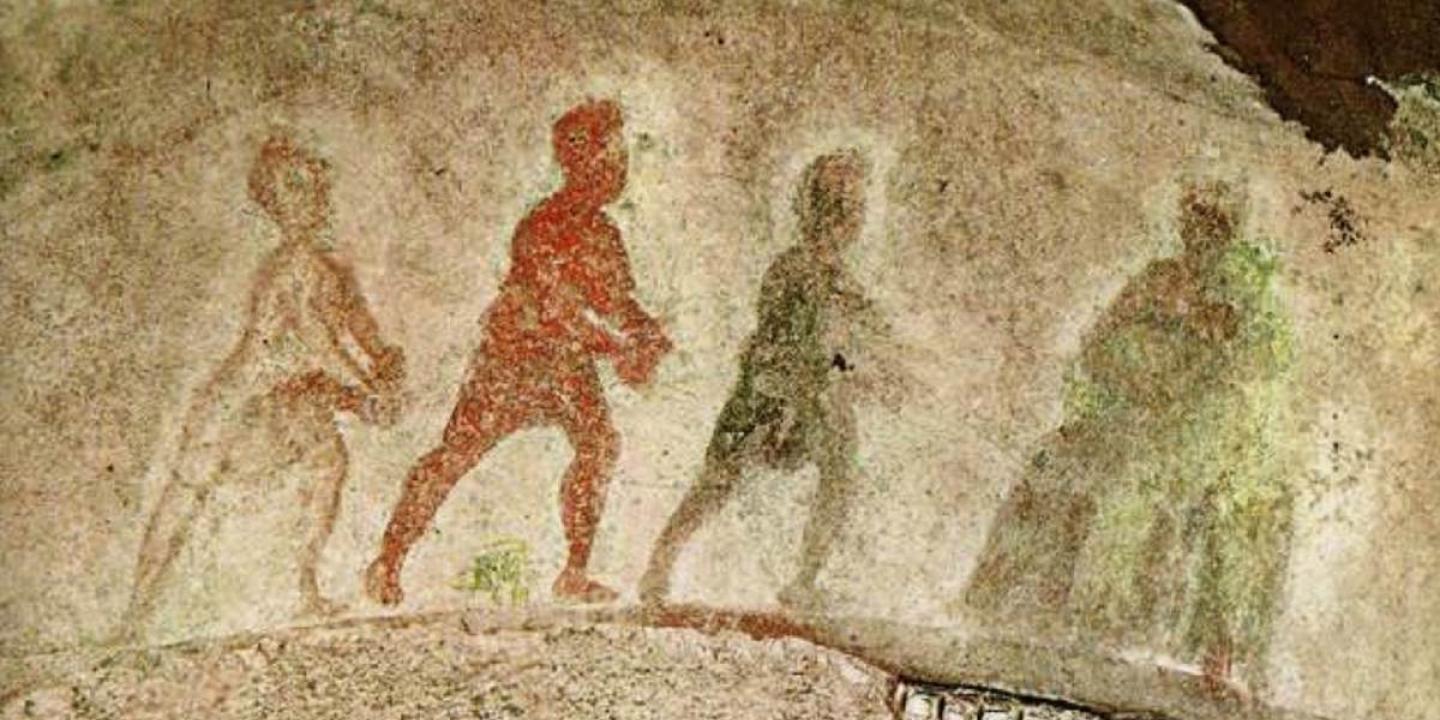 Silhouttes of three wise men approach the Virgin and Child, painted on stone.