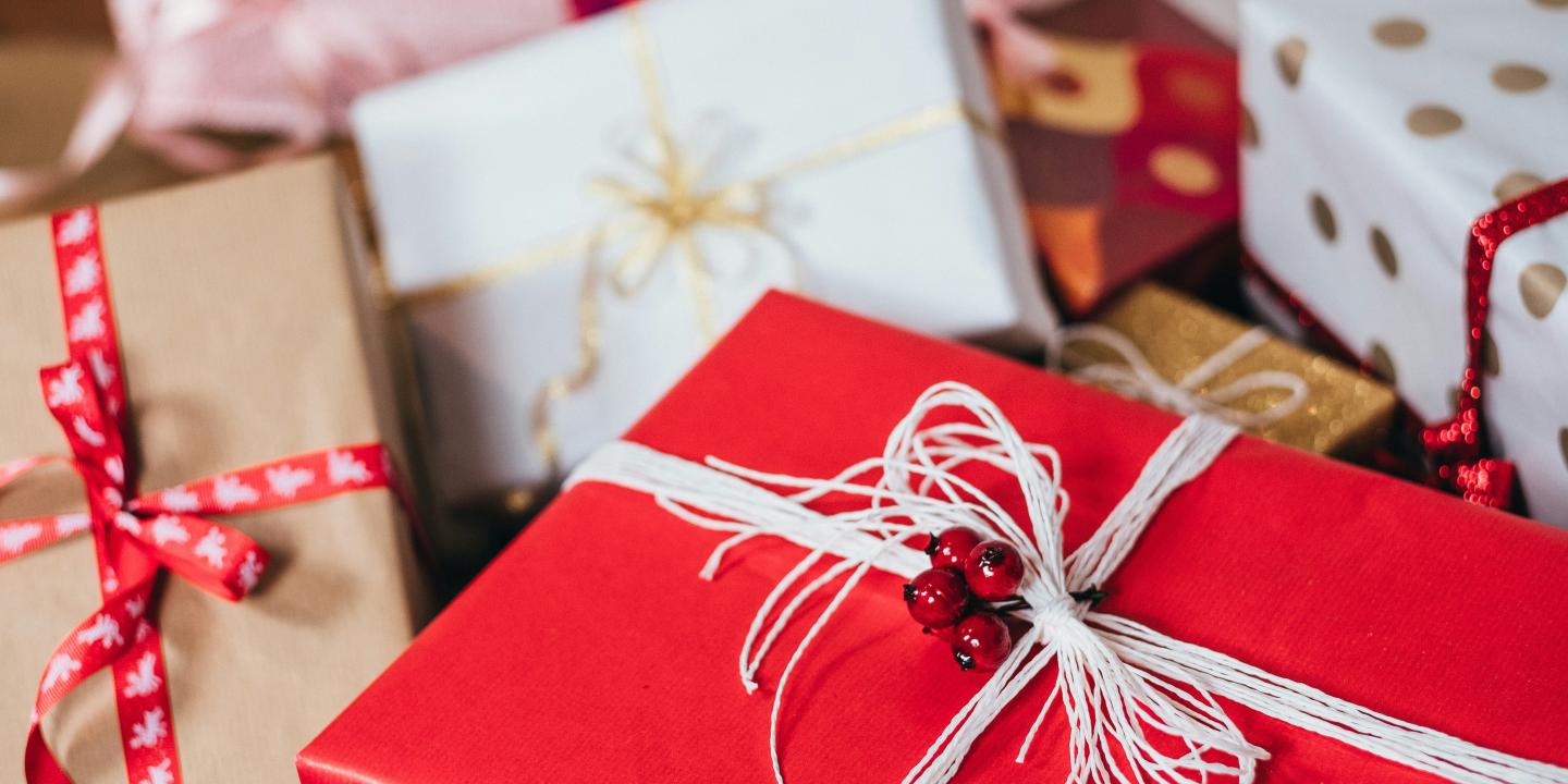 Christmas presents wrapped with red and white paper and string.