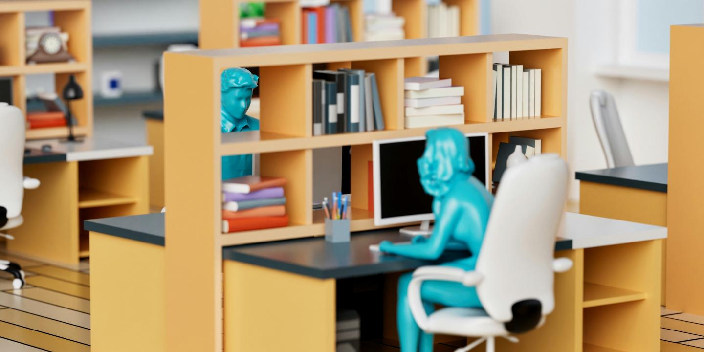 A model of an office desk and shelves, at which a green plastic person sits leaning into the desk.