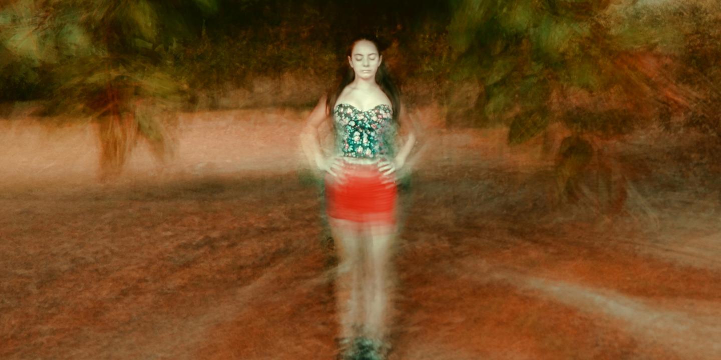 A montage image places a woman, with eyes shut and hands on hip, at the centre of blurred circle of ground and tree branches.