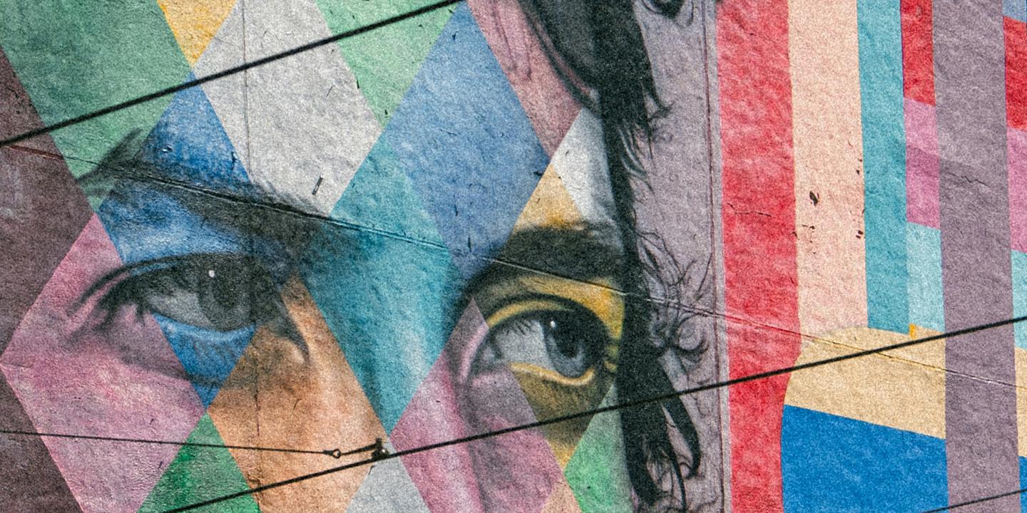 A colorful mural depicts the eyes of Bob Dylan staring to the side.