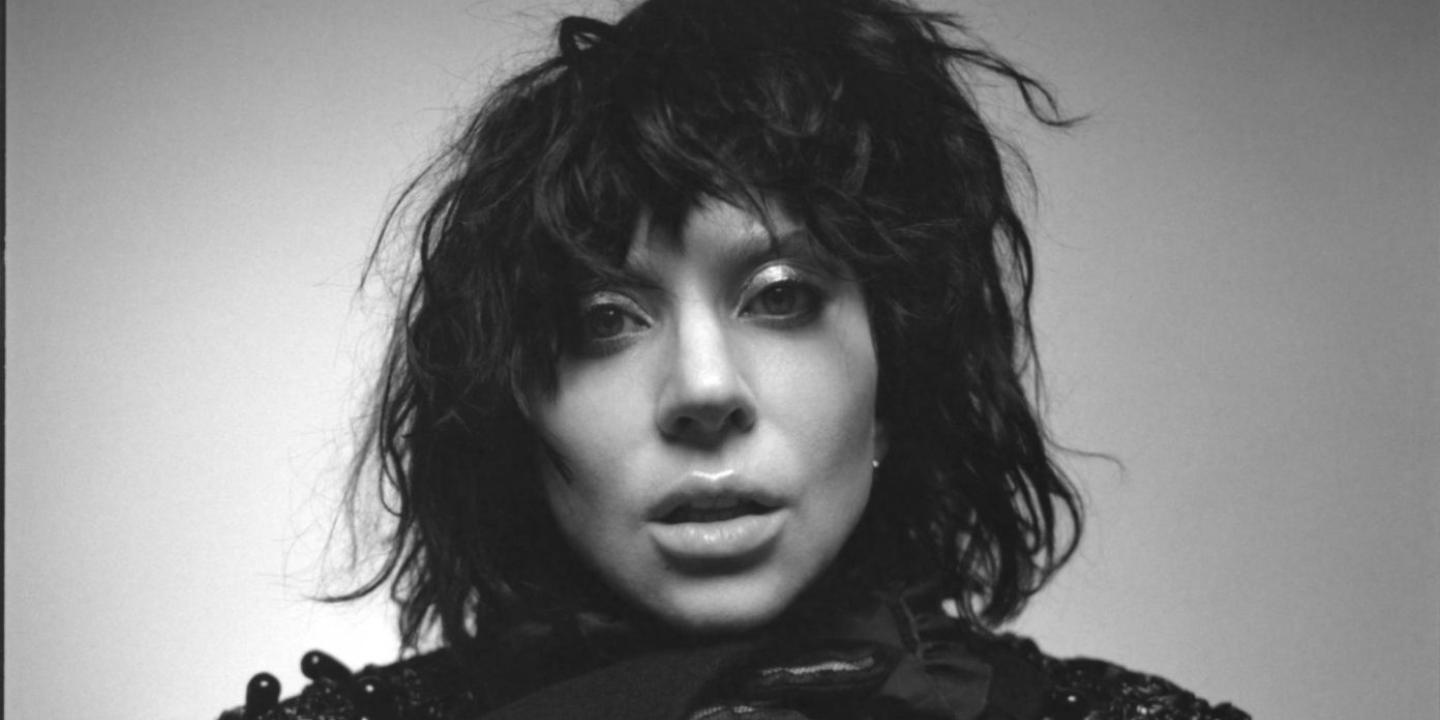 A black and white photo of a woman about to open her mouth to sing.