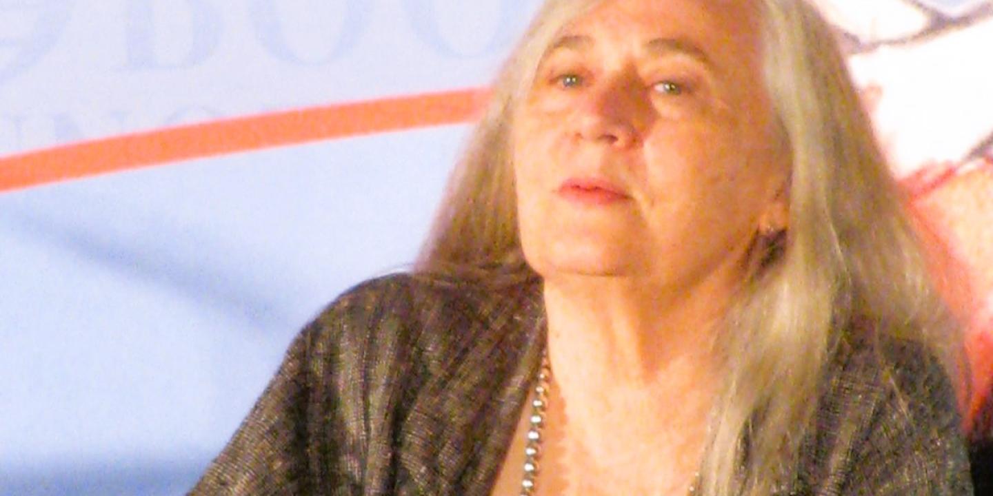 An author sits and listens.