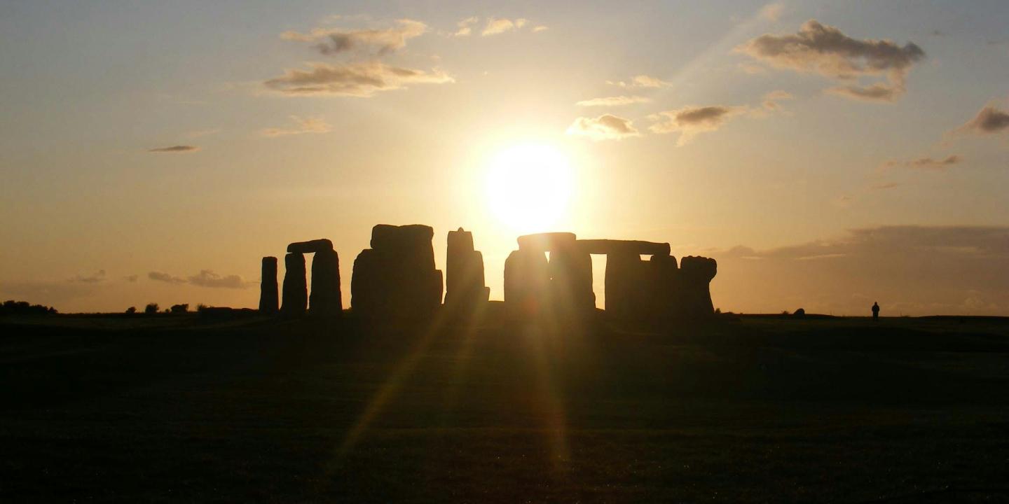 Sun rise casts a shadow over Stonehenge.