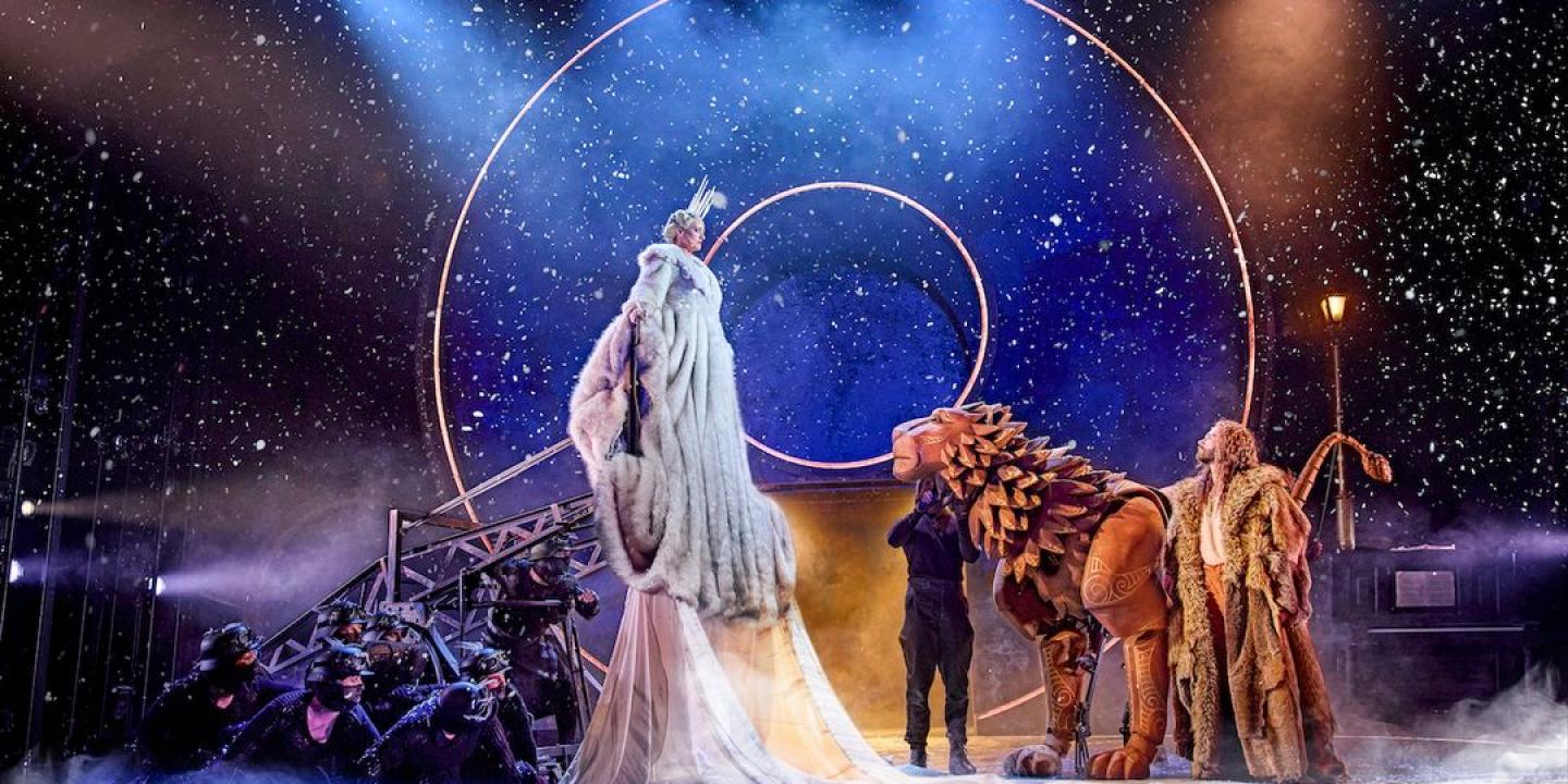 A play set shows a witch and lion on stage.
