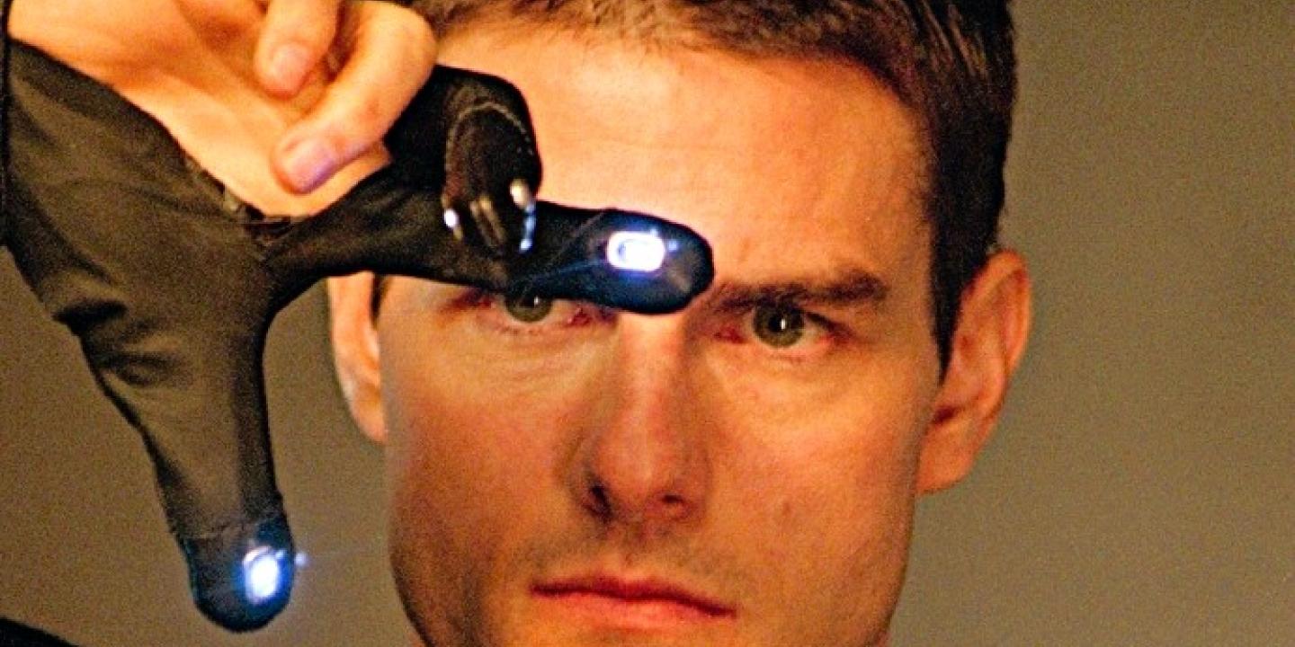 Tom Cruise gestures with his fingers in an e-glove in front of his face