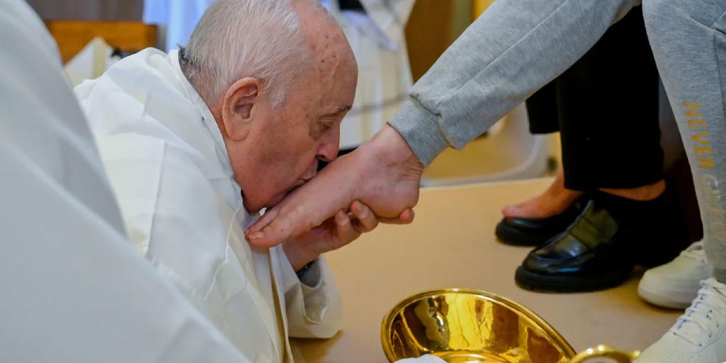 The Pope kisses a foot he has just washed.