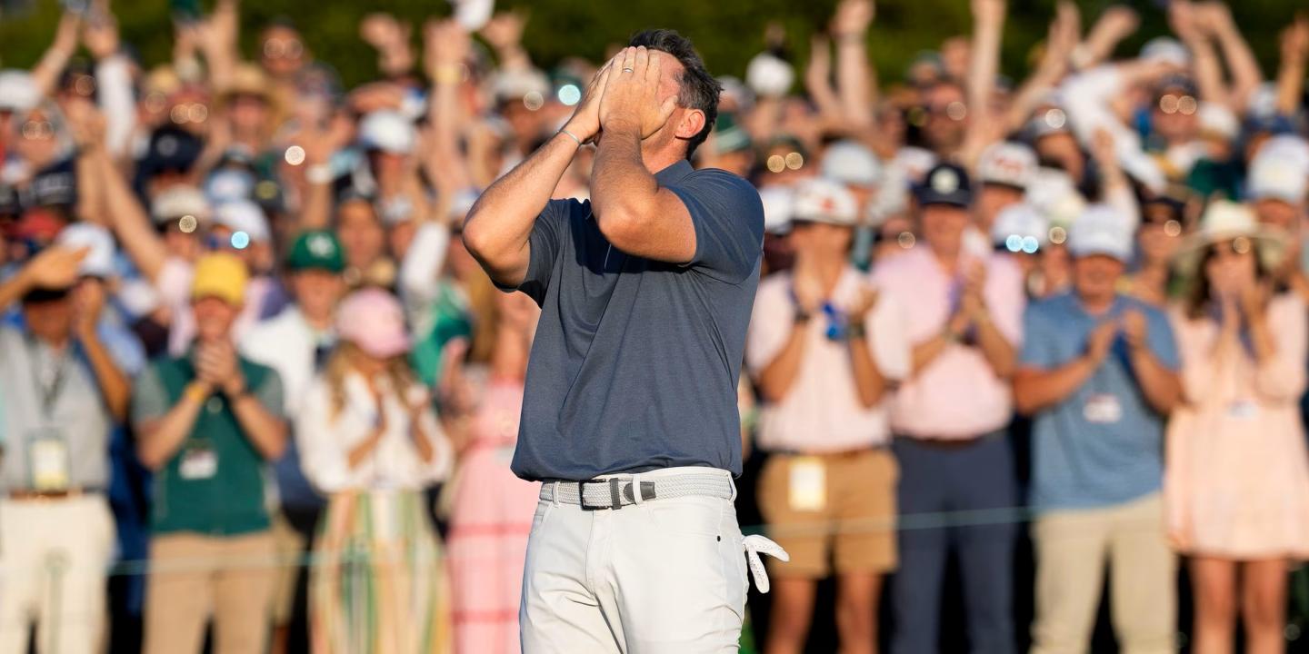 A golf clutches his face after winning a competition