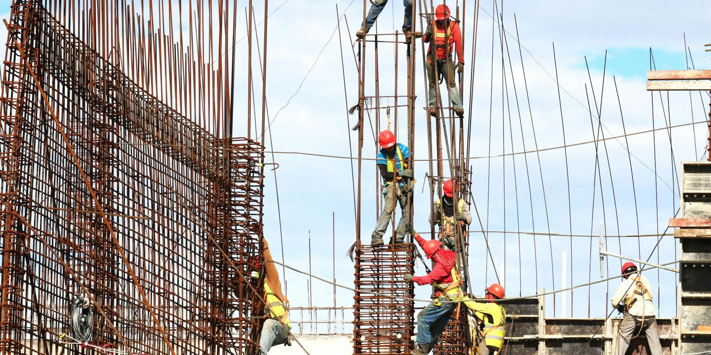 Construction worker climb a steel framework.