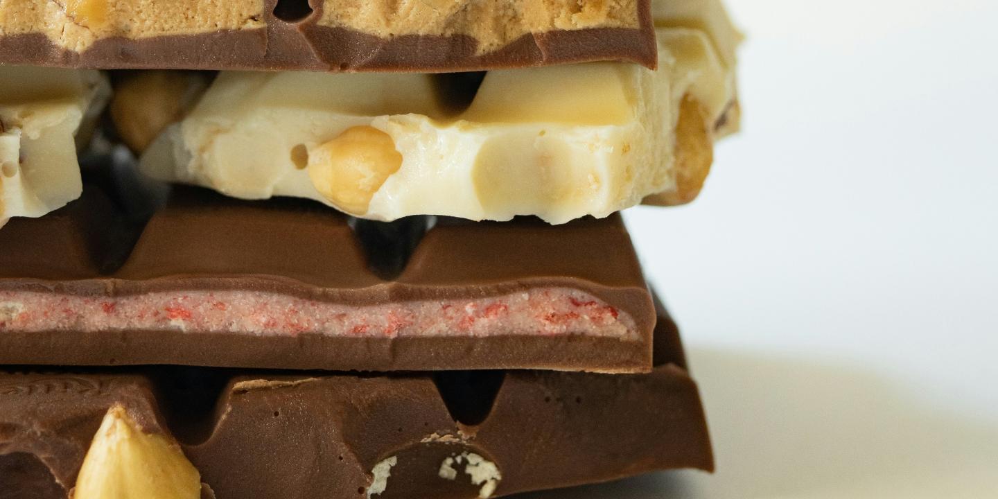 Broken bars of chocolate piled upon each other.