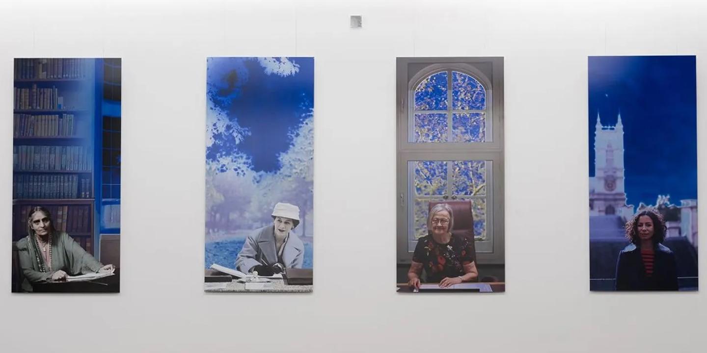 A paiting shows four panels featuring women lawyers over a century