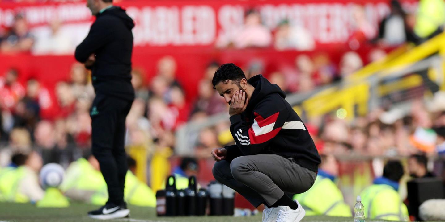 A dejected football coach squats by the byline.