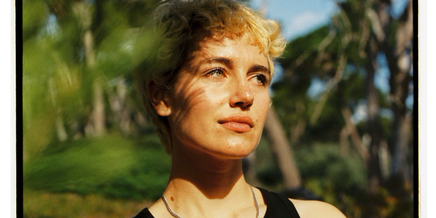A woman stares away from the camera